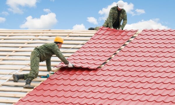 Two,Workers,On,Roof,At,Works,With,Metal,Tile,And