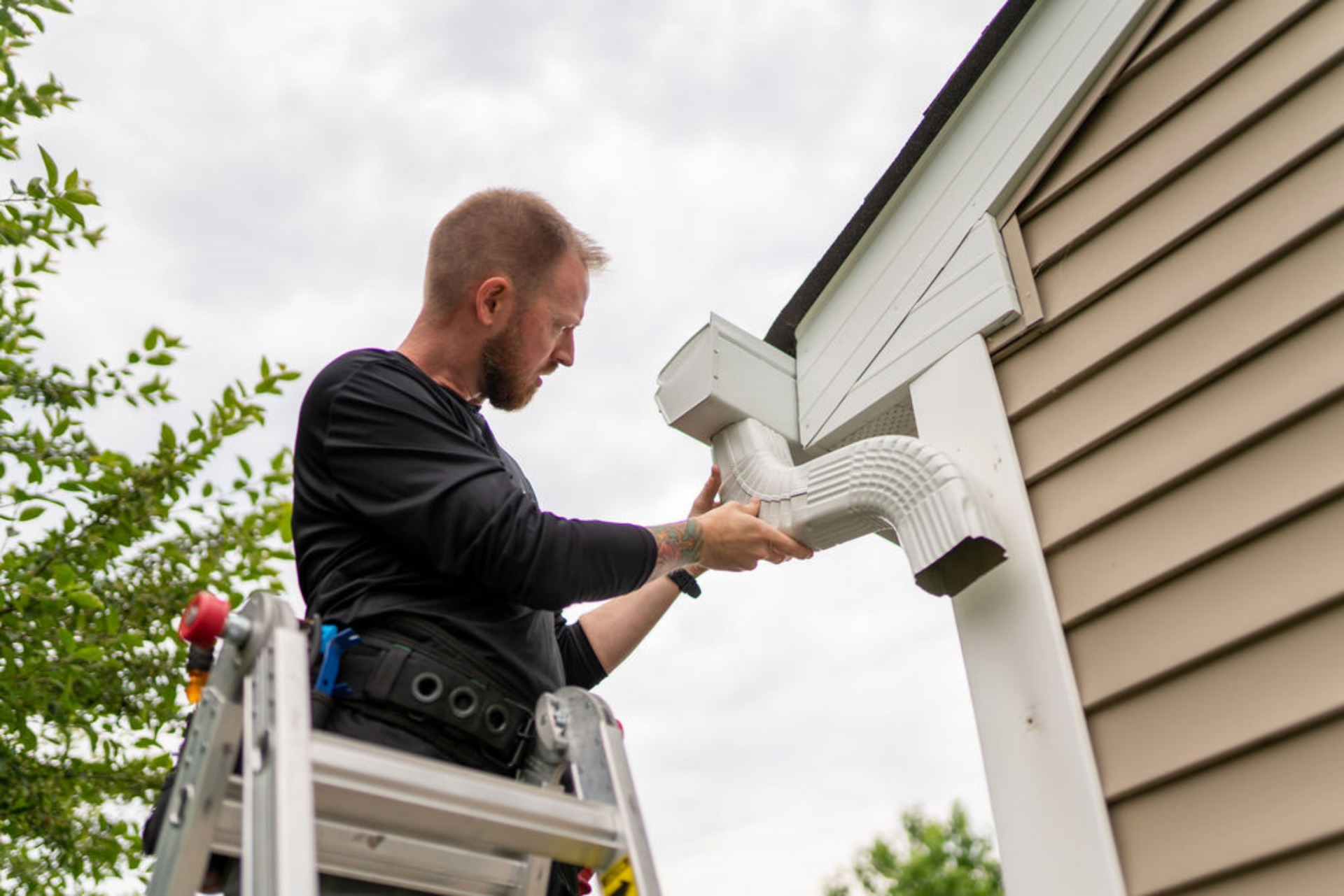 person installing new gutter