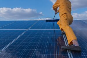 person with professional kit cleaning solar panel