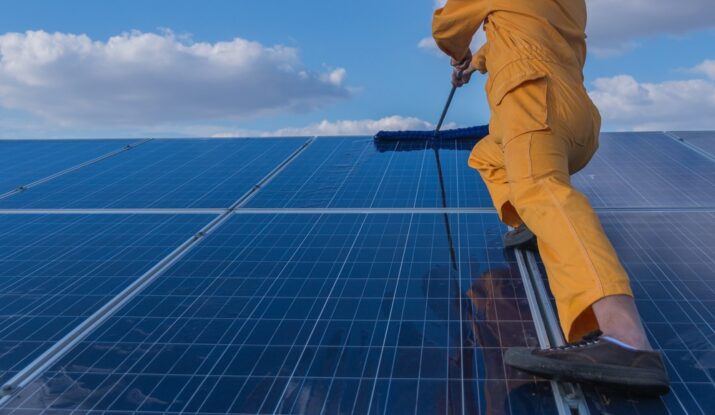 person with professional kit cleaning solar panel