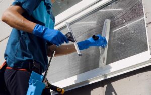 person cleaning window with professional kit